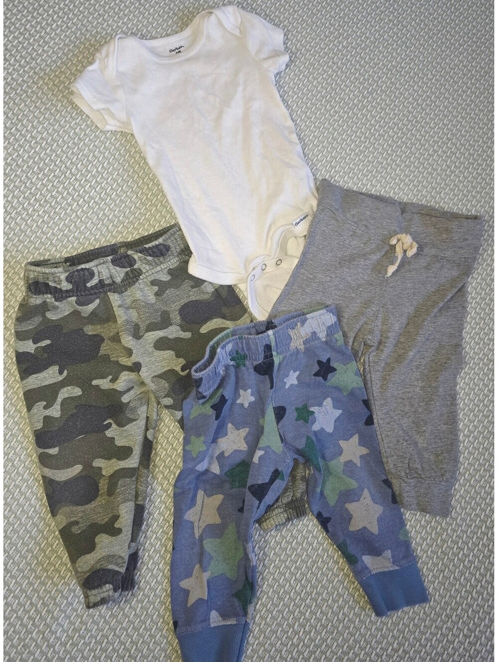 Four piece set one bodysuit and three pants boys size 6 to 9 months